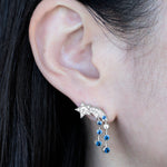 © イリーシージュエリー / Ery,C Jewelry / Eryc Jewelry / erycjewelry / eryc jewelry。夜sora（夜空）コレクションの星 ピアスとコメットと三日月 リング。天の川と流れ星、三日月と星をモチーフにしたハイジュエリーで、天然のカナダマークダイヤモンド（CanadaMark™ ハート＆アロー・ラウンドブリリアント）0.6ct、天然サファイア0.7ct、天然タンザナイト（カボション）3ct、天然ダイヤモンド0.3ct、プリンセスカットダイヤモンド0.6ct、ファンシーライトイエローダイヤモンド0.7ct、天然サファイア0.6ctを使用。Comet star earrings and moon ring from the Ery,C Jewelry Yozora collection, featuring natural CanadaMark™ hearts and arrows diamond, sapphire and tanzanite with milky way motif.
