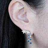 © イリーシージュエリー / Ery,C Jewelry / Eryc Jewelry / erycjewelry / eryc jewelry。夜sora（夜空）コレクションの星 ピアスとコメットと三日月 リング。天の川と流れ星、三日月と星をモチーフにしたハイジュエリーで、天然のカナダマークダイヤモンド（CanadaMark™ ハート＆アロー・ラウンドブリリアント）0.6ct、天然サファイア0.7ct、天然タンザナイト（カボション）3ct、天然ダイヤモンド0.3ct、プリンセスカットダイヤモンド0.6ct、ファンシーライトイエローダイヤモンド0.7ct、天然サファイア0.6ctを使用。Comet star earrings and moon ring from the Ery,C Jewelry Yozora collection, featuring natural CanadaMark™ hearts and arrows diamond, sapphire and tanzanite with milky way motif.